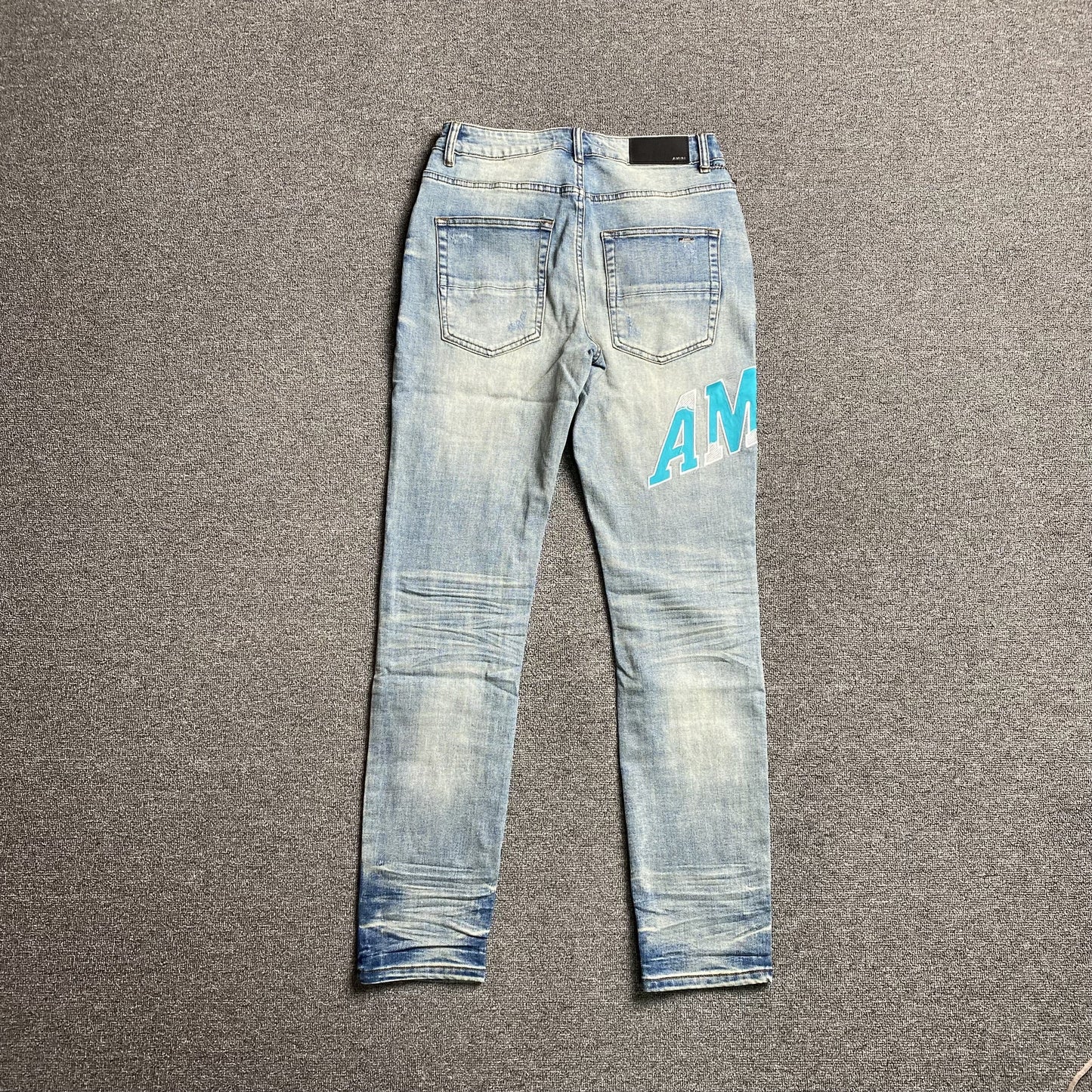 AMIRI VARSITY LOGO JEANS