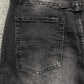 AMIRI VARSITY LOGO REPAIR JEANS